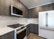 Thumbnail 15 of 49 - a kitchen with a stove microwave and refrigerator
