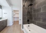 Thumbnail 18 of 49 - a bathroom with a tub and a shower and a sink