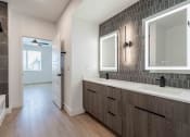 Thumbnail 17 of 49 - a bathroom with a sink and a mirror