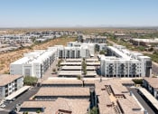 Thumbnail 49 of 49 - a cityscape of white buildings with a desert in the background