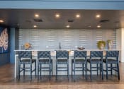 Thumbnail 31 of 49 - a large table with chairs in front of a wall with a geometric pattern