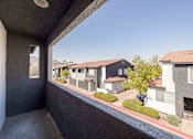 Thumbnail 43 of 63 - a balcony with a view of some houses and a street