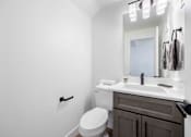 Thumbnail 41 of 63 - a bathroom with a sink toilet and a mirror