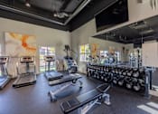 Thumbnail 5 of 63 - a spacious fitness room with cardio equipment and a large mirror