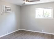 Thumbnail 9 of 30 - A room with a window and a ceiling fan.