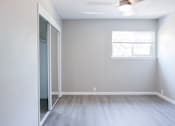 Thumbnail 10 of 30 - A room with a sliding glass door and a window.