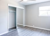 Thumbnail 13 of 30 - A room with a sliding door and a window.