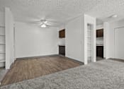 Thumbnail 4 of 18 - A room with a ceiling fan and wooden flooring.