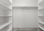 Thumbnail 6 of 18 - Empty white shelves in a room.
