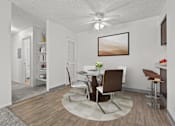 Thumbnail 9 of 18 - A dining room with a white table and chairs.