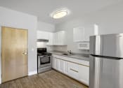 Thumbnail 15 of 32 - A kitchen with white cabinets and a stainless steel refrigerator.