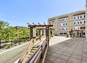 Thumbnail 4 of 32 - A building with a red wooden structure in front of it.