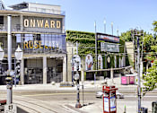 Thumbnail 9 of 32 - A street view of a building with a sign that reads "ONWARD ROSE CITY".
