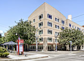 Thumbnail 2 of 32 - A large building with a red sign in front of it.