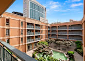 Thumbnail 2 of 12 - A courtyard with a pool surrounded by buildings at Pin Yuen, Sacramento, CA