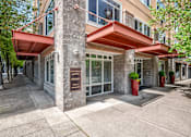 Thumbnail 8 of 32 - A building with a red awning and a sign on the front.