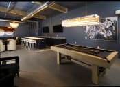 Thumbnail 2 of 28 - A game room with a pool table and a bar