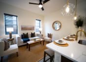 Thumbnail 4 of 28 - a living room with a kitchen and a dining table