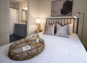 Thumbnail 8 of 28 - a bedroom with a bed and a bottle of wine on it