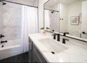 Thumbnail 9 of 28 - a bathroom with a sink and a shower and a tub