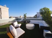 Thumbnail 25 of 28 - a roof top terrace with couches and a table