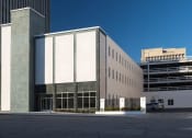 Thumbnail 27 of 28 - the exterior of a building with a parking lot
