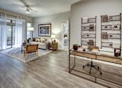 Thumbnail 23 of 40 - A living room with a wooden floor and a ceiling fan at Arise Riverside Apartments, Austin, TX