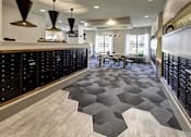 Thumbnail 8 of 40 - A modern kitchen with black cabinets and a grey hexagonal rug at Arise Riverside Apartments, Austin