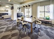Thumbnail 11 of 40 - A modern dining room with a wooden table and chairs at Arise Riverside Apartments, Texas