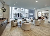 Thumbnail 5 of 40 - A modern living room with a kitchen area and a dining area at Arise Riverside Apartments, Austin, Texas