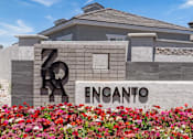 Thumbnail 2 of 31 - a building with a sign and flowers in front of it at Zora Encanto, Phoenix, 85035