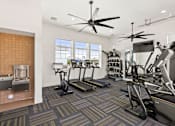 Thumbnail 19 of 31 - a gym with treadmills and other exercise equipment and a window at Zora Encanto, Phoenix, AZ