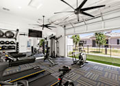 Thumbnail 14 of 31 - a gym with weights and cardio equipment and a large window at Zora Encanto, Phoenix, Arizona