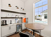 Thumbnail 21 of 31 - a kitchen and dining area with a large window and a table at Zora Encanto, Phoenix