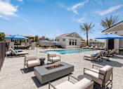 Thumbnail 1 of 31 - a swimming pool with chairs and tables and umbrellas at Zora Encanto, Arizona 85035