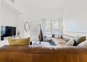 Thumbnail 14 of 25 - a living room with a leather couch and a tv