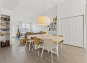Thumbnail 10 of 25 - a dining room and living room with a table and chairs
