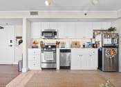 Thumbnail 24 of 35 - a kitchen with stainless steel appliances and white cabinets