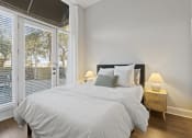 Thumbnail 32 of 35 - a bedroom with a large bed and a large window