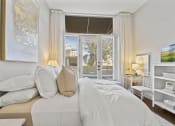 Thumbnail 14 of 35 - a bedroom with a large bed and a window