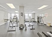 Thumbnail 28 of 35 - a gym with various machines and weights in it