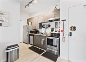 Thumbnail 5 of 24 - a kitchen with stainless steel appliances and white walls