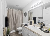 Thumbnail 4 of 26 - a bathroom with a shower and a sink and a toilet