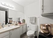 Thumbnail 24 of 26 - a bathroom with a sink and a toilet and a mirror