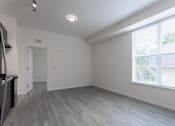 Thumbnail 15 of 24 - A spacious room with a grey floor and white walls.