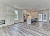 Thumbnail 11 of 73 - A spacious kitchen with a marble wall and a wooden floor.