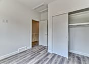 Thumbnail 23 of 73 - A room with a white door and a grey carpet.