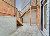 Thumbnail 6 of 73 - A concrete staircase leads up to a wooden deck.