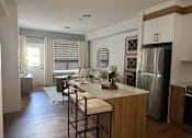 Thumbnail 24 of 31 - A kitchen with a bar stool and a counter.at The Pointe at Riverview, Alberta, T6M 3H4
