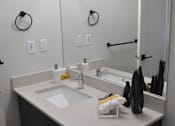Thumbnail 2 of 9 - A bathroom with a sink and mirror at The Laurent at Laurel Apartments, Edmonton, AB